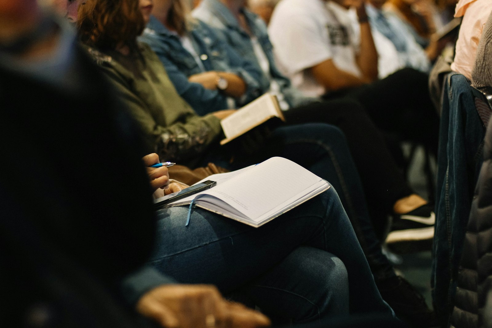 People studying with notebooks and Bibles